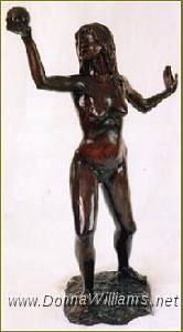 A life-size bronze sculpture of a nude young woman, holding an apple high in her right hand and gazing into it. Her left hand is behind her, palm out, as if to ward something off.
